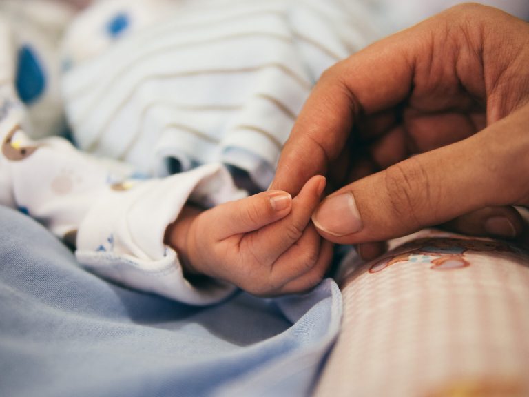 mother holding baby in hospital